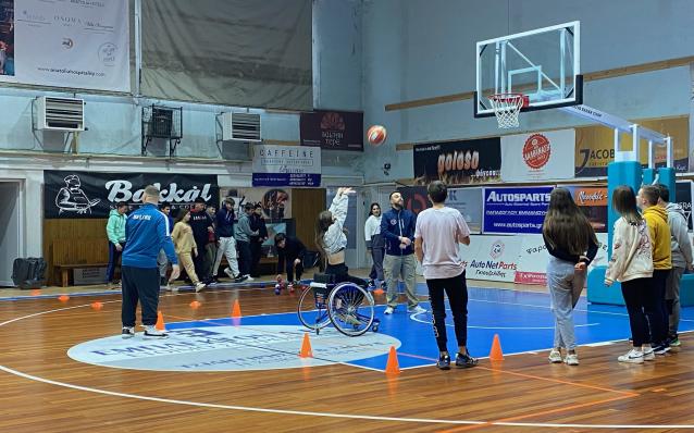 Student playing wheelchair basketball 