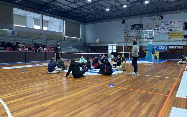 Students playing sitting volleyball