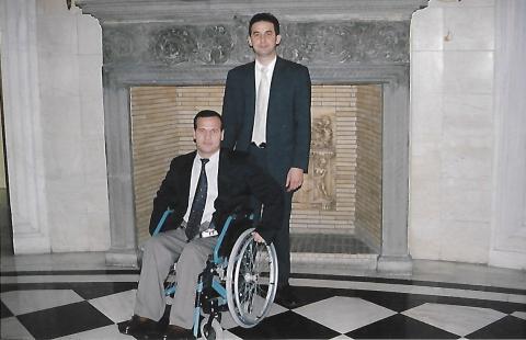 photo of two men, one is a wheelchair user and the other one is standing, they are in greek president‘s house