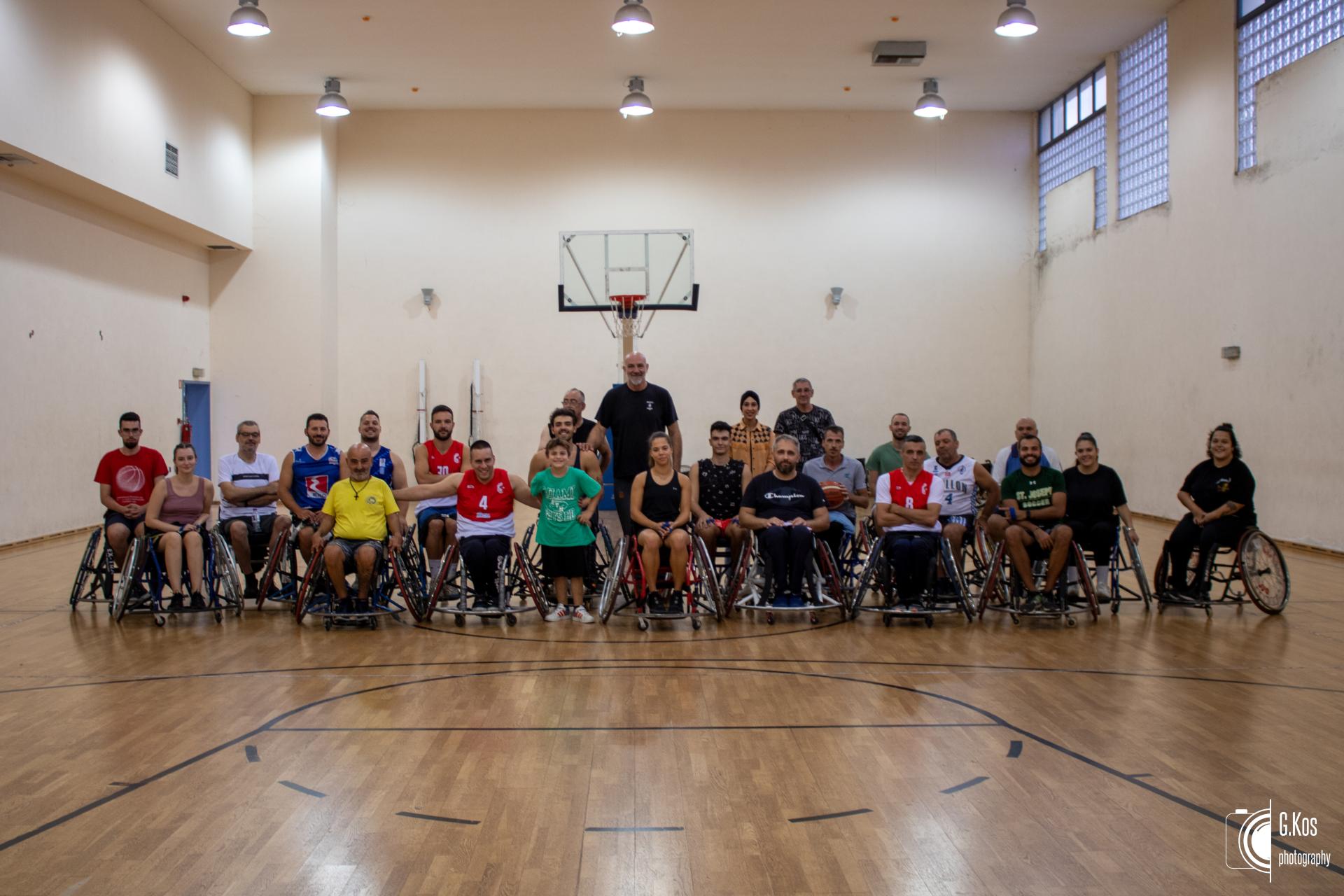 Image description:the photo shows a group of people all sitting in basketball wheelchairs and all looking long at the camera.
