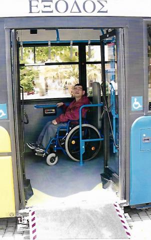 photo of a man who is a wheelchair user and he is on a bus which is accessible