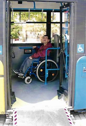 male wheelchair user on a city bus